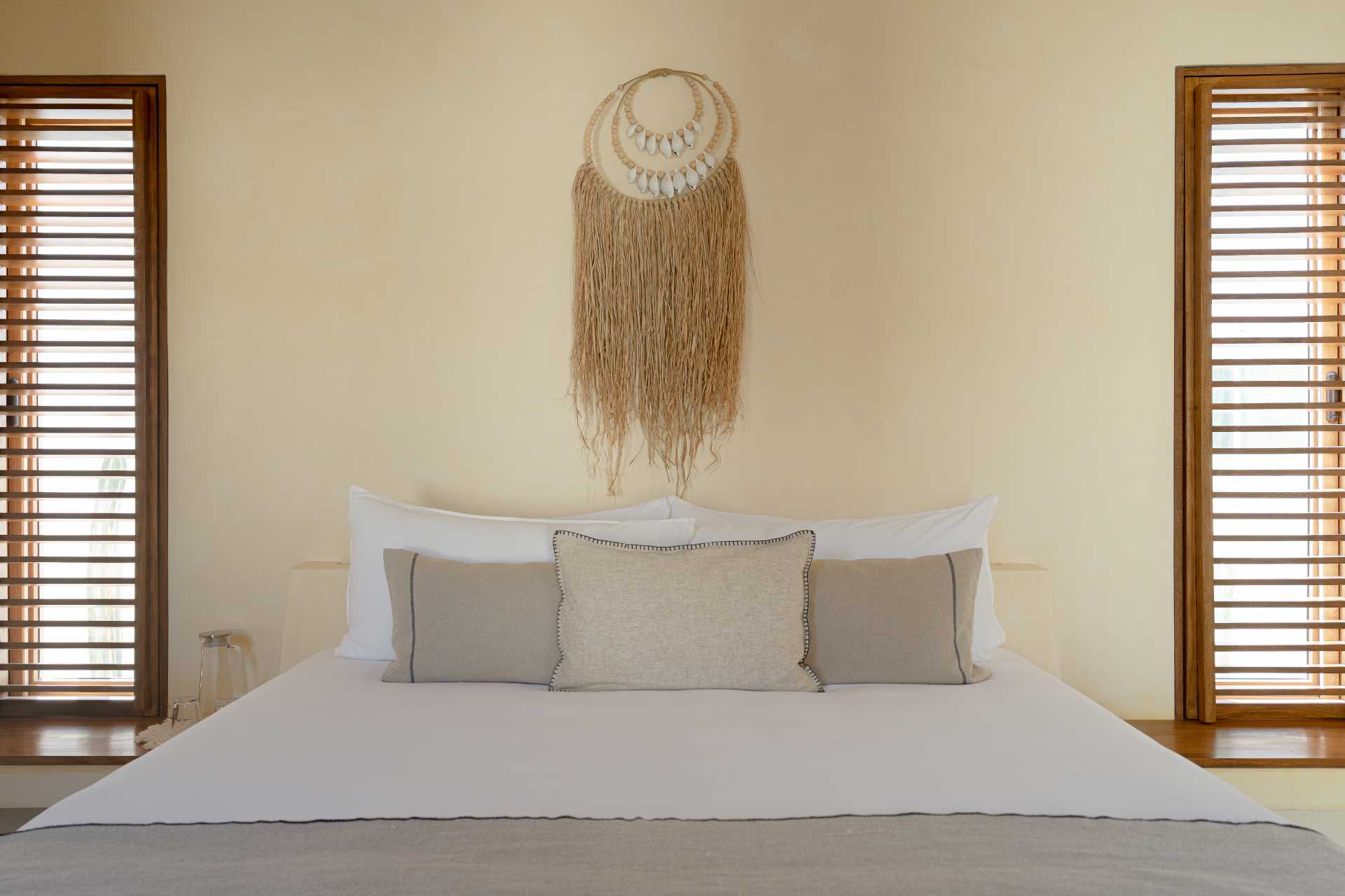 A contemporary beachside bedroom with a neutral palette.