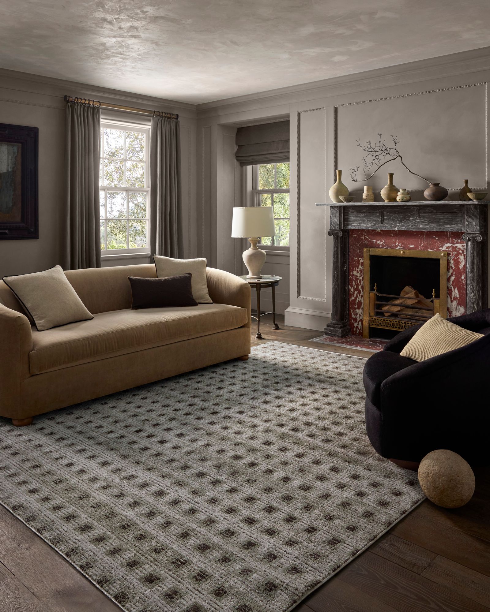 Image may contain Home Decor Rug Couch Furniture Lamp Fireplace and Indoors