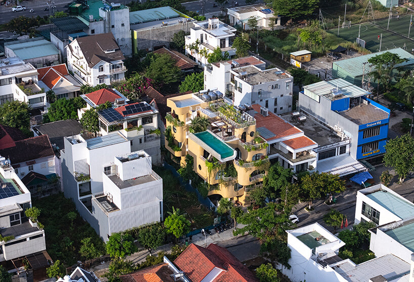 rooftop pool cantilevers from the facade of ho khue architects' hotel in vietnam