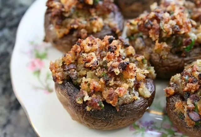 Stuffed mushrooms on a decorative plate.