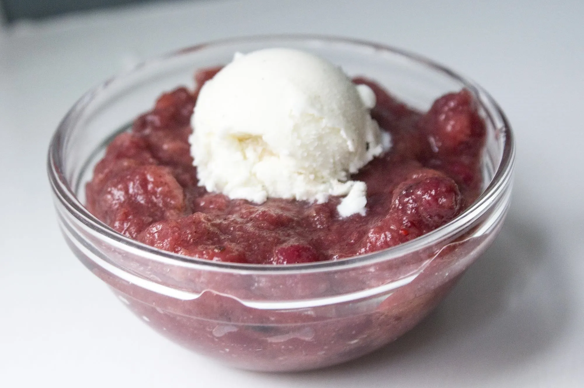 Cherry compote topped with vanilla ice cream.