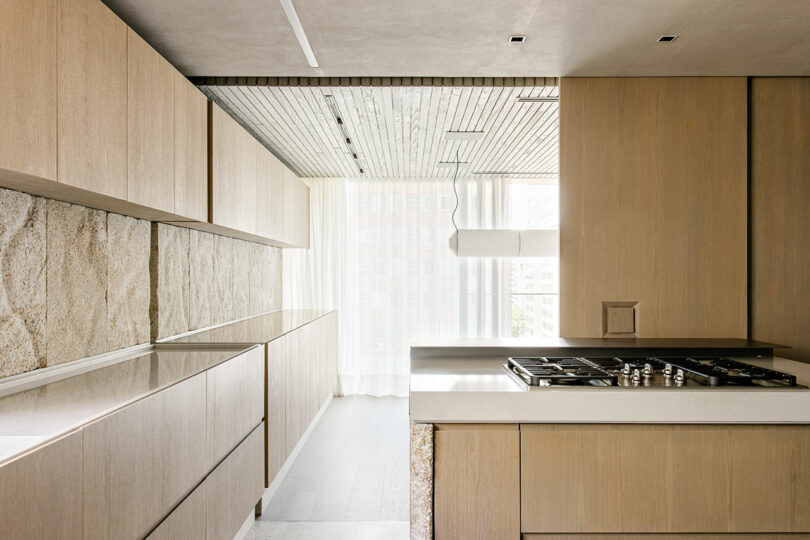 A kitchen with wood cabinets and a stove.